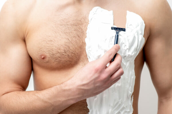 Young,Caucasian,Man,With,Beard,Holds,Razor,Shaves,His,Chest Young,Caucasian,Man,With,Beard,Holds,Razor,Shaves,His,Chest
